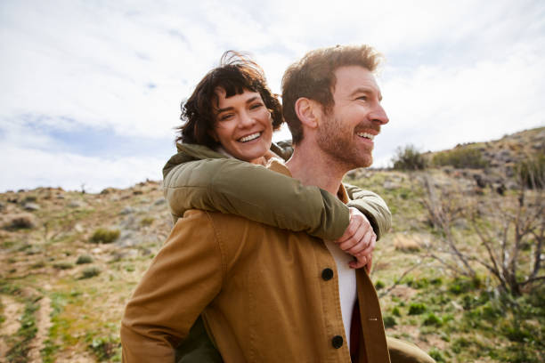 istock Laughing young couple having fun while hiking together 1221852449