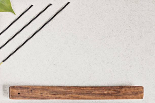 istock Incense sticks with a stand on a gray background. Aromatherapy. Spa home concept 1221852590