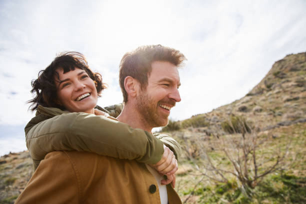 istock Laughing young couple having fun while out hiking together 1221852613