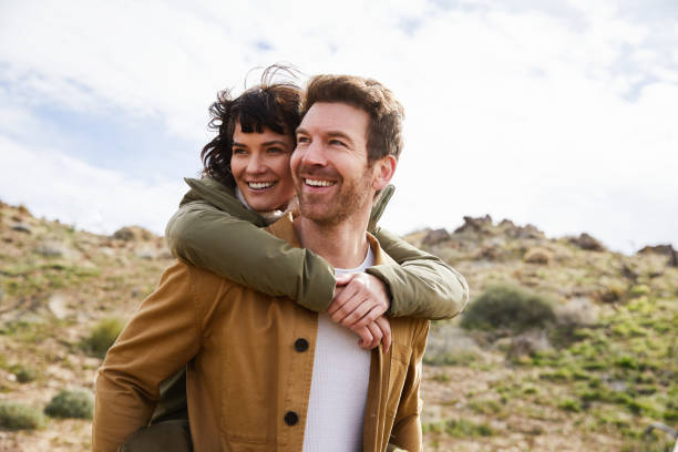 istock Smiling young couple having fun while out hiking together 1221852760