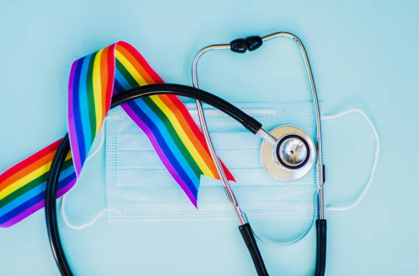 Stethoscope and LGBT rainbow ribbon pride symbol. Blue background Stethoscope and LGBT rainbow ribbon pride symbol. Blue background lgbtqia culture photos stock pictures, royalty-free photos & images