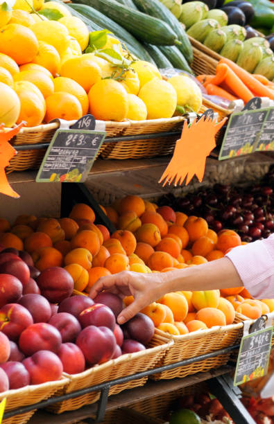 istock Woman Choosing Fruit at Market. 1221853774