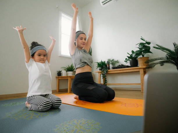istock Young mother and daughter making a exercises at home. 1221854535