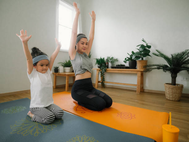 istock Young mother and daughter making a exercises at home. 1221854546