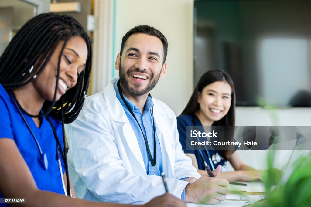Medical students smile during meeting in conference room Doctor Stock Photo