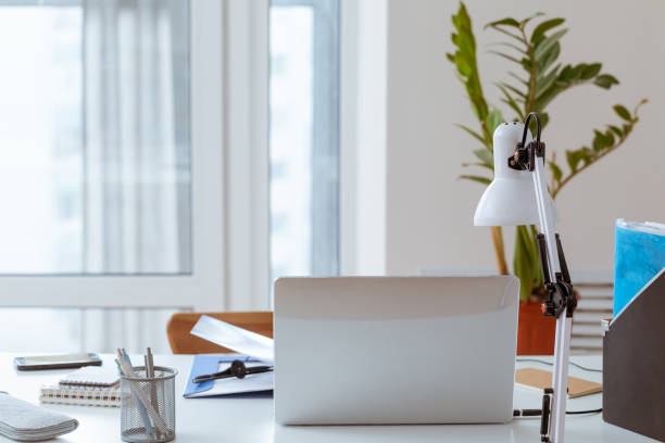 istock Workplace with laptop at home on window background. 1221857415