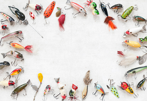 Vintage Fishing Lures on an Old White Wood Background