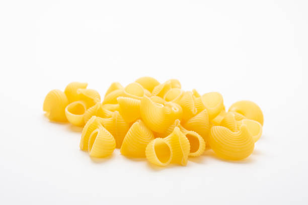 istock Striped sea shell shaped pasta isolated on white background 1221858965