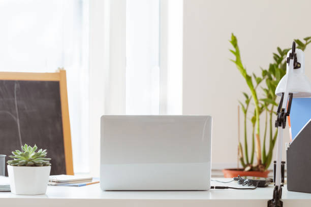 istock Workplace with laptop at home on window background. 1221859013