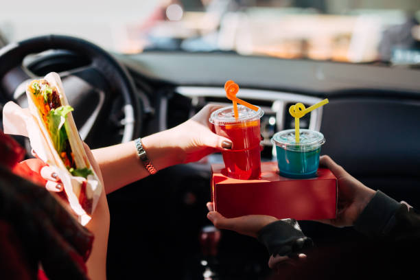 istock Driver eating and drinking in the car 1221860315