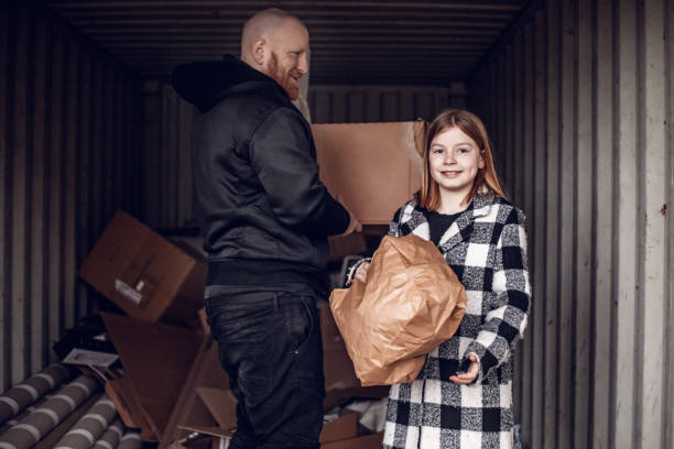 istock Father and daughter recycling paper 1221862076