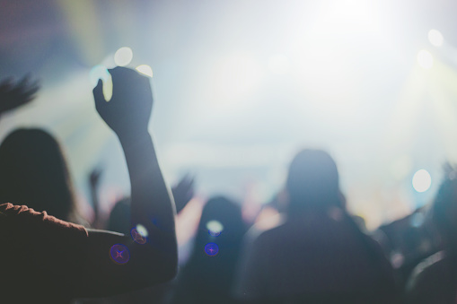 Softfocus of Christian worship with raised hand,music concert