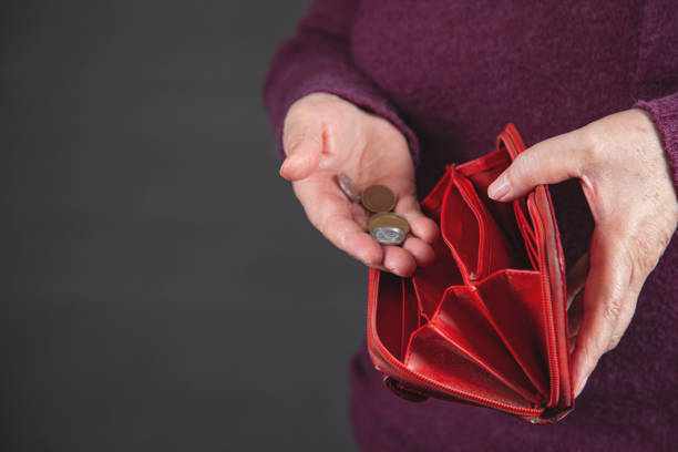 istock woman holding coin on grey background 1221862191