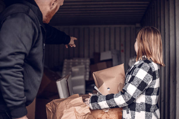 istock Father and daughter recycling paper 1221862198