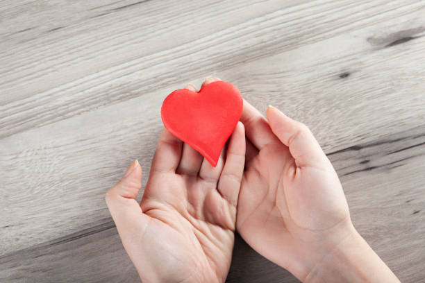 istock woman hand red heart 1221862307