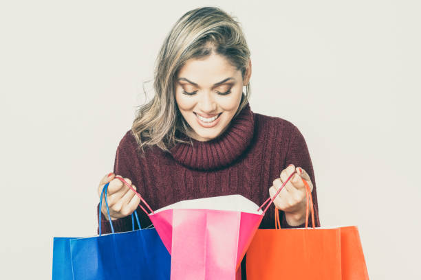 istock Cheerful woman looking into shopping bag 1221862379