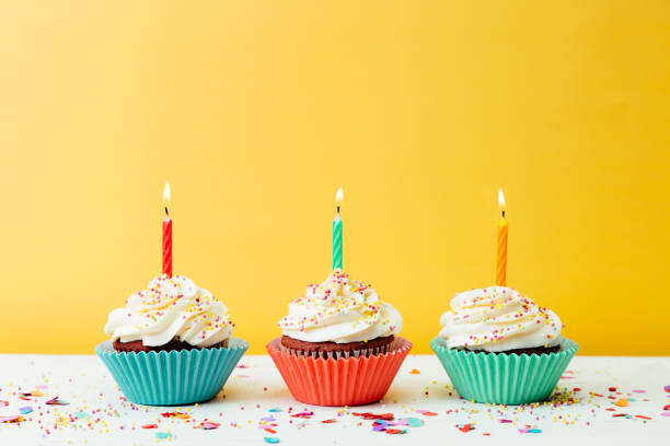 istock Cupcakes for birthday party on yellow background 1221862769