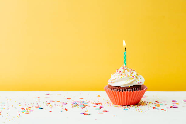 istock Colorful cupcake for birthday party on yellow background 1221862771