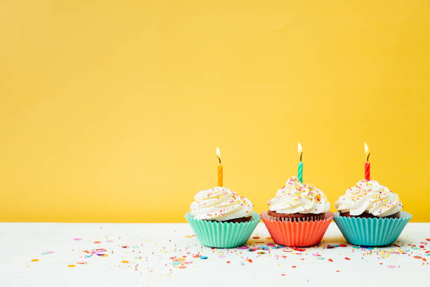 istock Colorful birthday cupcakes on yellow background 1221862775