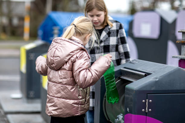 istock Two Young girls at a recycling centre 1221863499