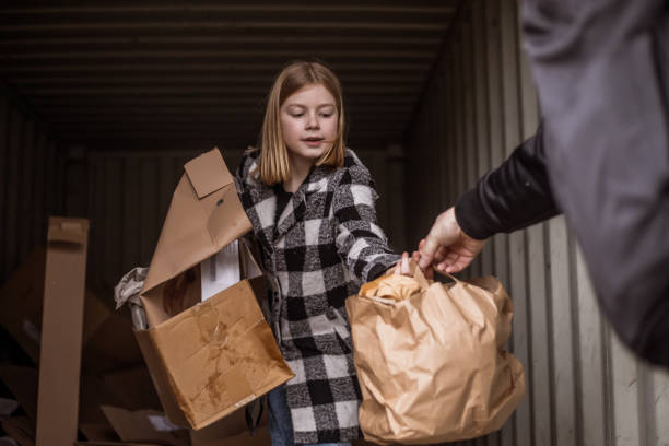 istock Father and daughter recycling paper 1221864000