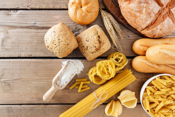 istock Breads and different types of pasta on a wooden  background, copy space. 1221864011