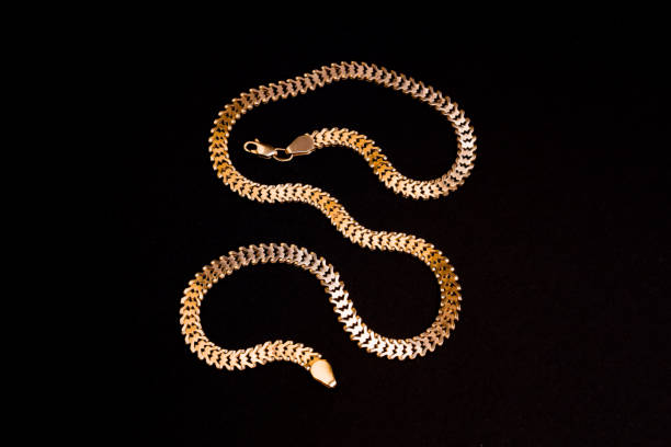 istock Big gold necklace on black background 1221864137