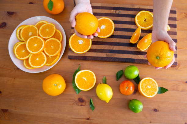 istock Woman holding two oranges in hands 1221865020