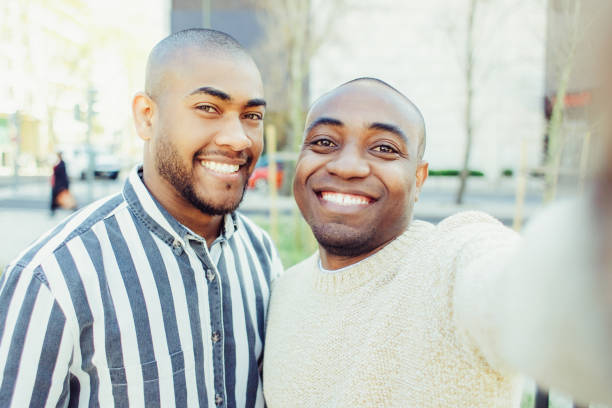 istock Smiling African American friends taking selfie 1221866955