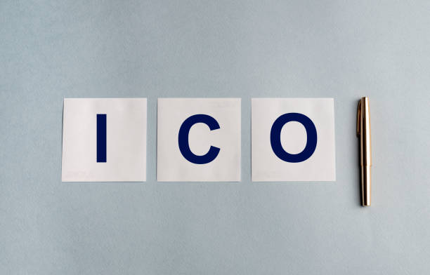 istock ICO text on white stickers memo notes and pen on blue table 1221867902
