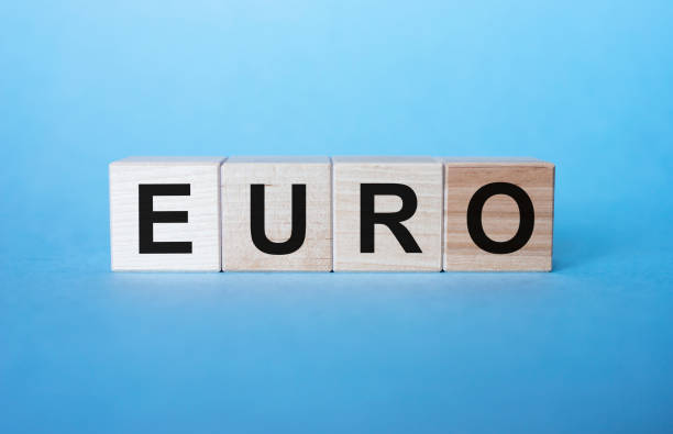 istock Wooden cubes with word EURO on blue table. Cubes letters. 1221867904