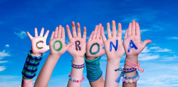 istock Children Hands Building Word Corona, Blue Sky 1221870005