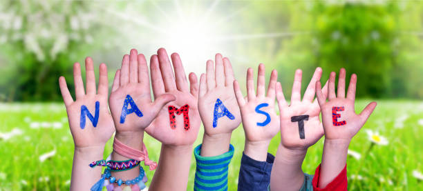 istock Children Hands Building Word Namaste Means Hello, Grass Meadow 1221870322