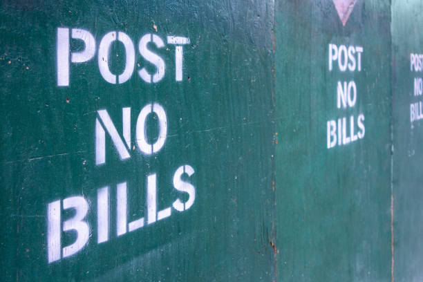 istock post no bills spray painted text letters on closed off unrban contrustion area 1221871358