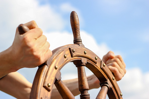 Steering hand wheel ship on sky background