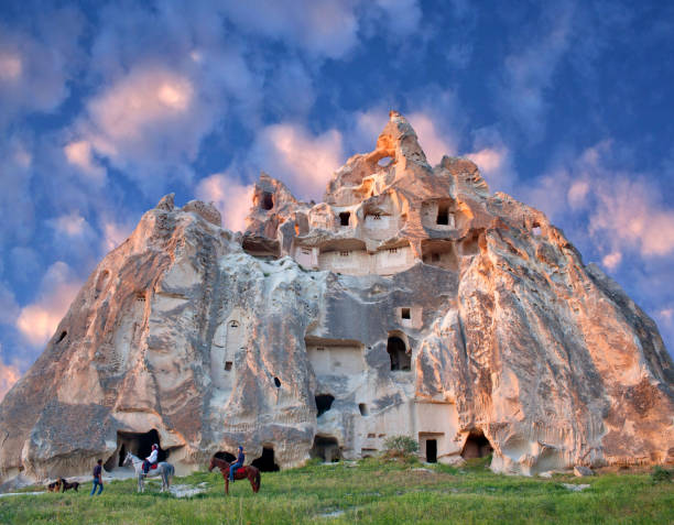 Unique geological formations in Cappadocia, Turkey Goreme, Cappadocia, Turkey - May 16, 2016: Couple of horseback riders with guide walking in Red valley, Cappadocian region, Central Anatolia rock hoodoo stock pictures, royalty-free photos & images