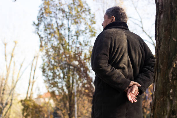 istock Senior man walking and relaxing in park 1221873453