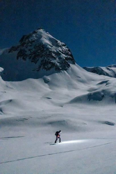 istock Backcountry skier ascends mountain at night 1221874173