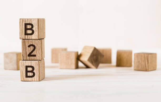 istock Three wooden cubes with letters B2B on white table, more in background. 1221874238