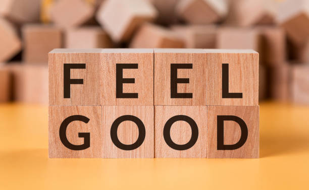 istock Cubes with a message feel good against the background of blurred cubes 1221874253