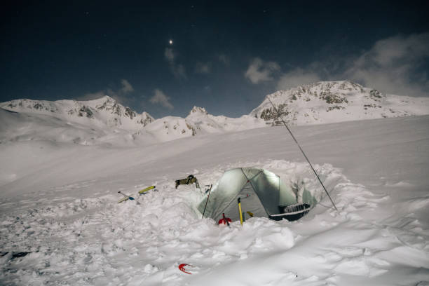 istock Illuminated tent rests in a snowy backcountry 1221874387