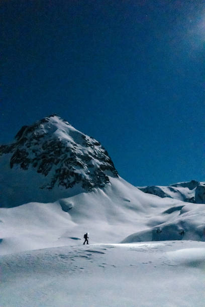 istock Backcountry skier ascends mountain at night 1221874677