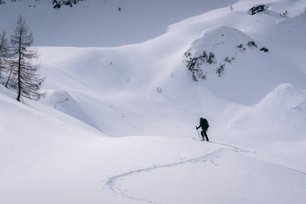 istock Backcountry skier ascends mountain 1221875916