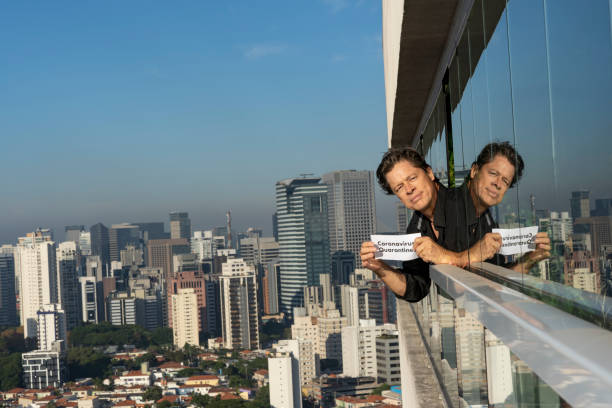 istock Quarantine. The mature man at home looking out the window. 1221876001