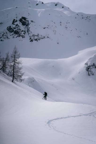 istock Backcountry skier ascends mountain 1221876077