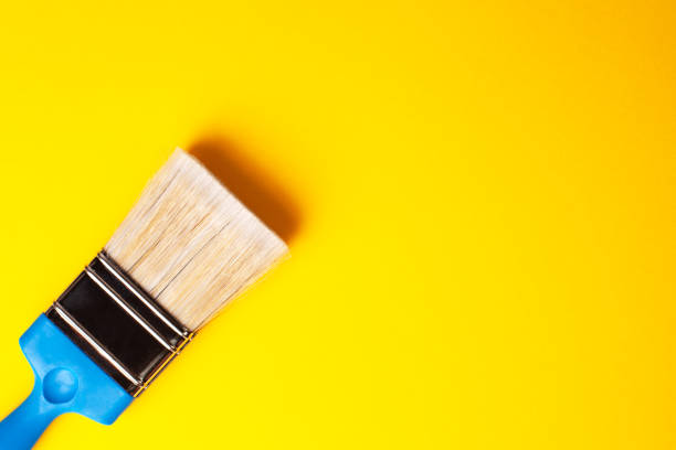 istock Paint brush close-up on a yellow background, copy paste, left orientation. 1221876079
