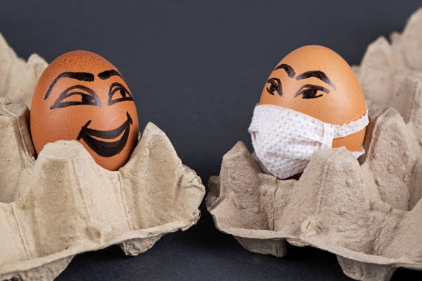 istock Eggs  wearing medical masks 1221876675