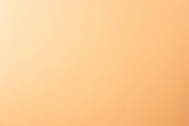 istock Light orange, peach color paper background, copy space. 1221879628