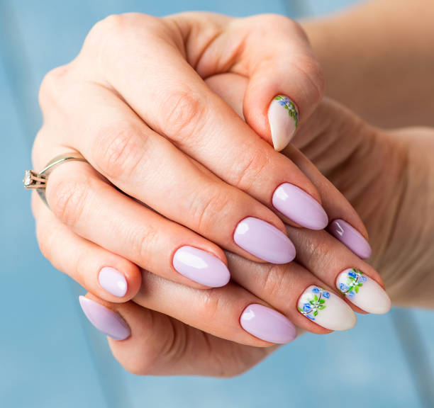 istock Nails Design. Hands With Bright lilac and White Manicure with Spring flowers. Close Up Of Female Hands. Art Nail. 1221880870