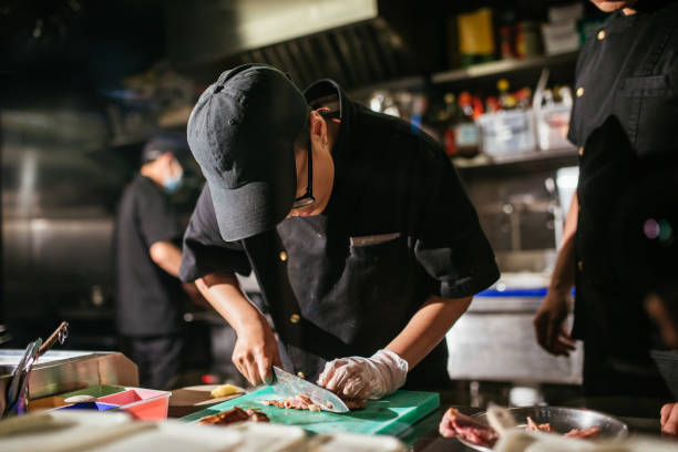 istock Chef working in restaurant kitchen, chopping grilled meat 1221881240